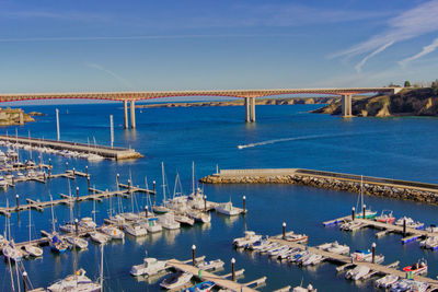 View of  a bridge and boats moored in sea