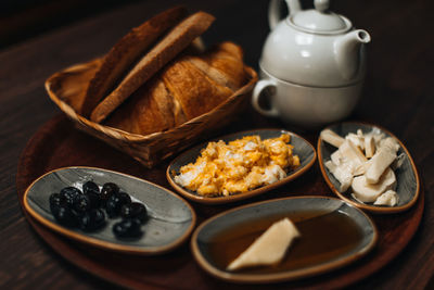 Traditional turkish breakfast with fried egg, olives, croissant, bread, cheese, butter,honey and tea 