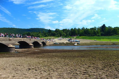 Scenic view of river against cloudy sky