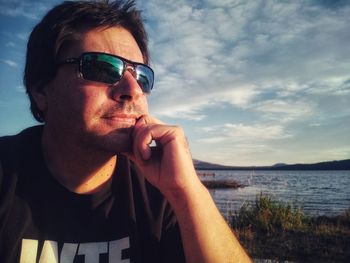 Portrait of man wearing sunglasses against sky