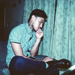 Portrait of young man sitting outdoors