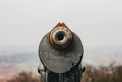 Close-up of coin-operated binoculars against cityscape in prague, czech republic.