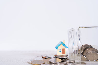 Close-up of glass jar on table against white background