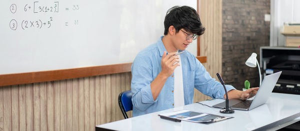 Side view of businesswoman working at office