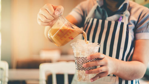 Midsection of woman holding ice cream