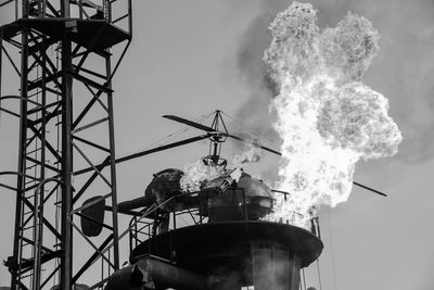 Low angle view of smoke stack against sky