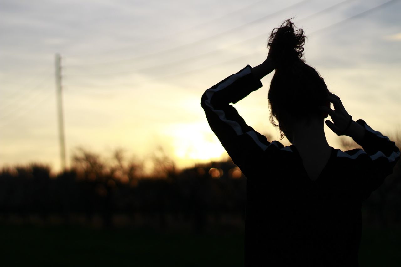 sunset, silhouette, sky, holding, person, men, lifestyles, focus on foreground, leisure activity, cloud - sky, technology, cloud, outdoors, photography themes, orange color, nature, field, part of