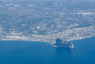 Aerial view of sea and snowcapped mountain