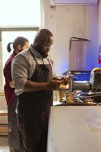 Side view of man working in workshop