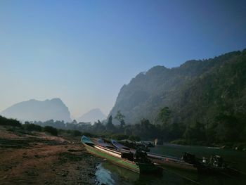 Scenic view of river and mountain against clear sky