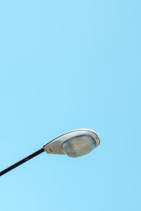 Low angle view of street light against blue sky