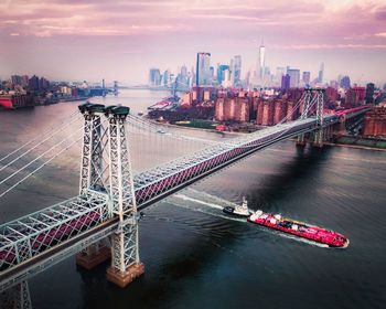 High angle view of bridge over river by buildings in city