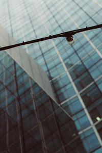 Low angle view of rope hanging on metal fence