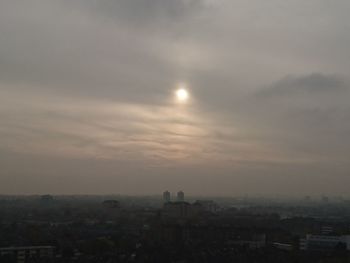 Scenic view of city against sky during sunset