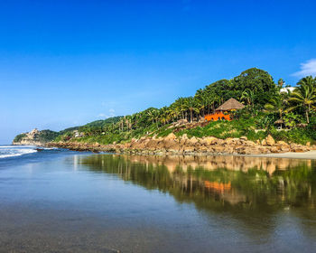 Scenic view of sea against clear blue sky