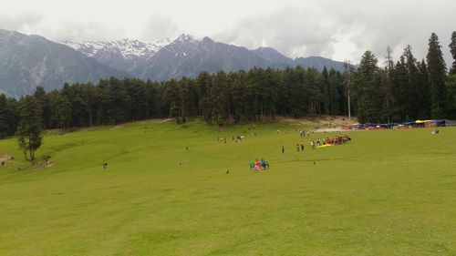 People on mountain against sky