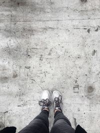 Low section of person standing on tiled floor