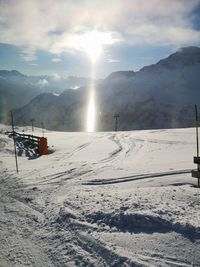 Scenic view of snow covered mountains against sky