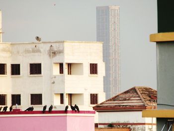 People on building against clear sky