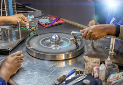 Cropped hands working over equipment 