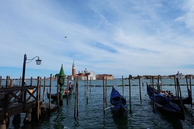 Boats on wooden post in water