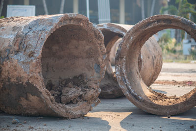 Close-up of rusty wheel on wood