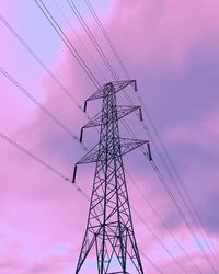 Low angle view of silhouette electricity pylon against sky during sunset