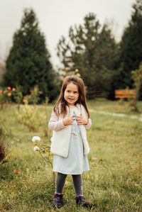 Portrait of girl standing on field