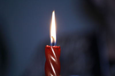 Close-up of illuminated red candle