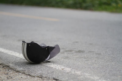 Close-up of black shoes on road