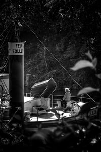 Information sign on boat against trees