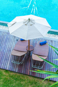 High angle view of chairs by swimming pool