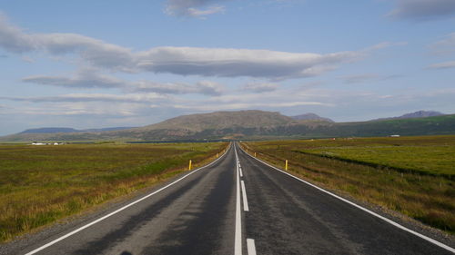 Empty road along countryside landscape