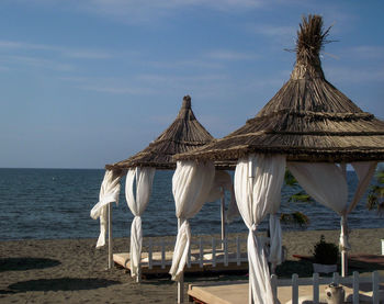 Gazebo on beach against sky