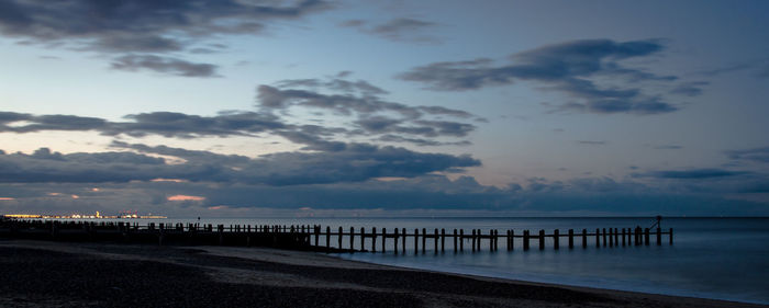 Pier on sea at sunset