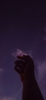 Low angle view of silhouette hand against sky at night