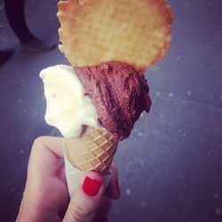 Close-up of hand holding ice cream cone