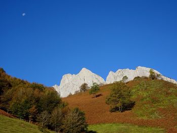 Scenic view of mountains against clear blue sky