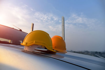 Close-up of yellow car against sky