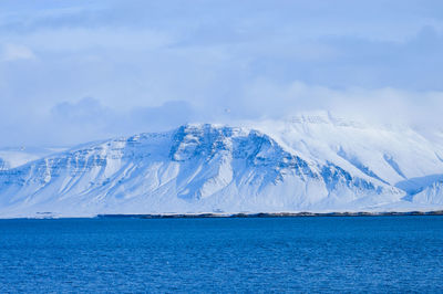 Scenic view of frozen sea against blue sky