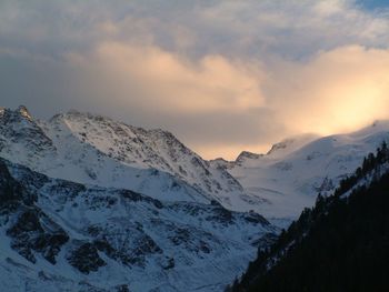 Scenic view of snowcapped mountains against sky during sunset