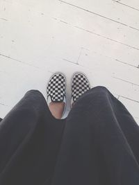 Low section of woman standing on tiled floor