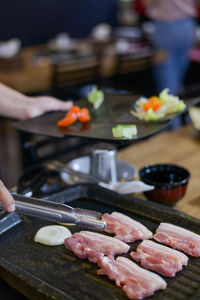 Person preparing food on table