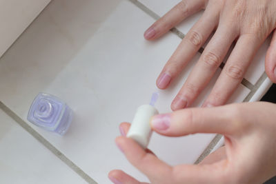 Cropped hand of person with nail polish