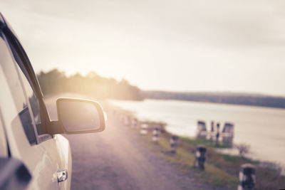 Car on road against sky during sunset