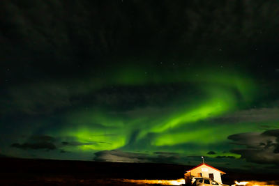 Scenic view of illuminated building against sky at night