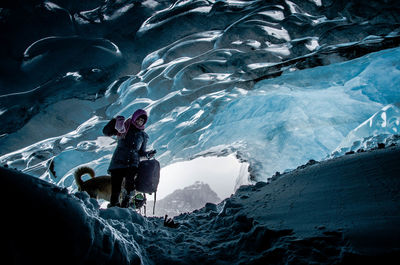 Woman standing in snowy cave