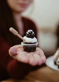 Close-up of hand holding cupcakes