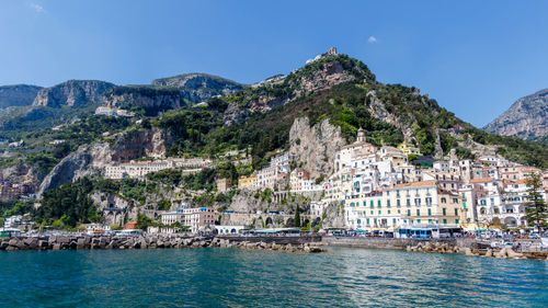 View of townscape by mountain against sky