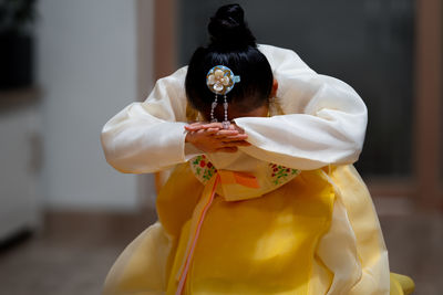 Midsection of woman holding flower